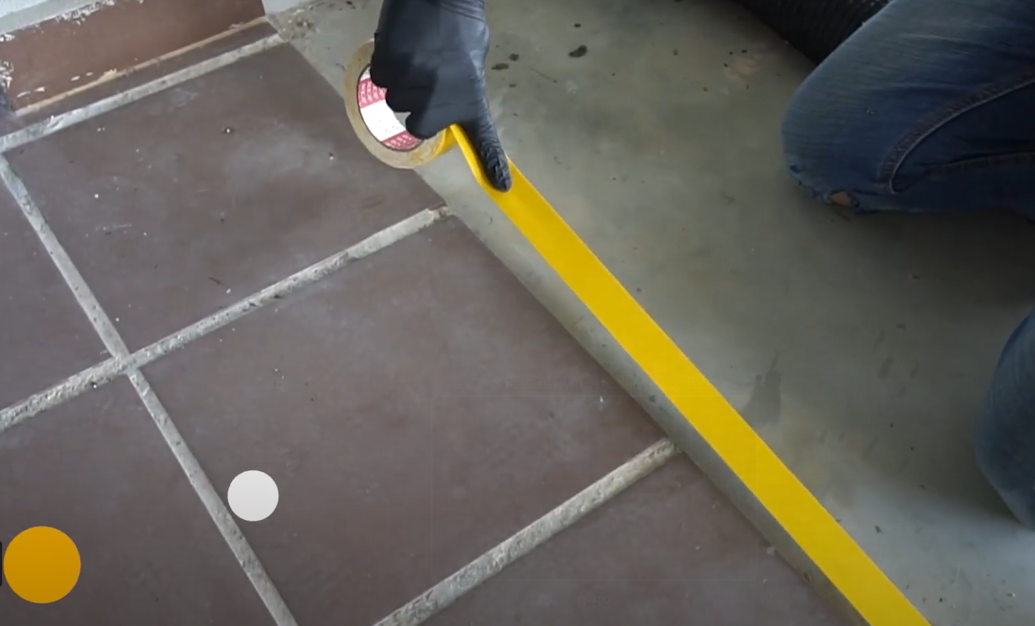 A worker using one of the artificial grass installation methods which is double-sided tape method.